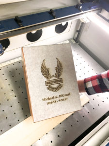 Laser engraving of Harley Davidson logo on metal memorial plaque.