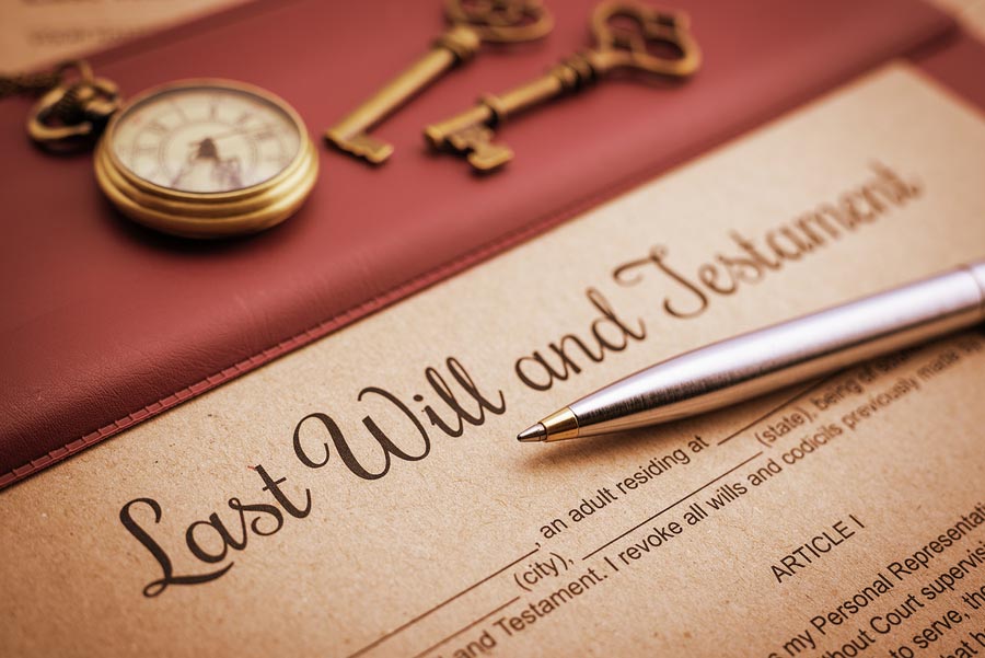 Last will and testament document with silver pen.