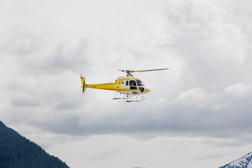 Yellow helicopter in-flight.