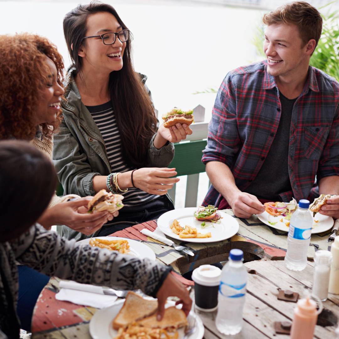 Group of people gathering to eat and have a good time.