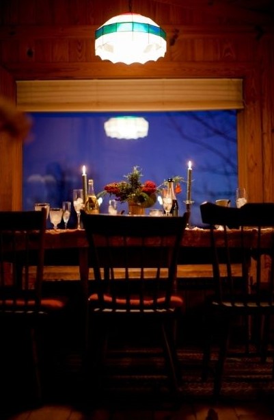 Table prepared for a holiday meal with empty chairs.