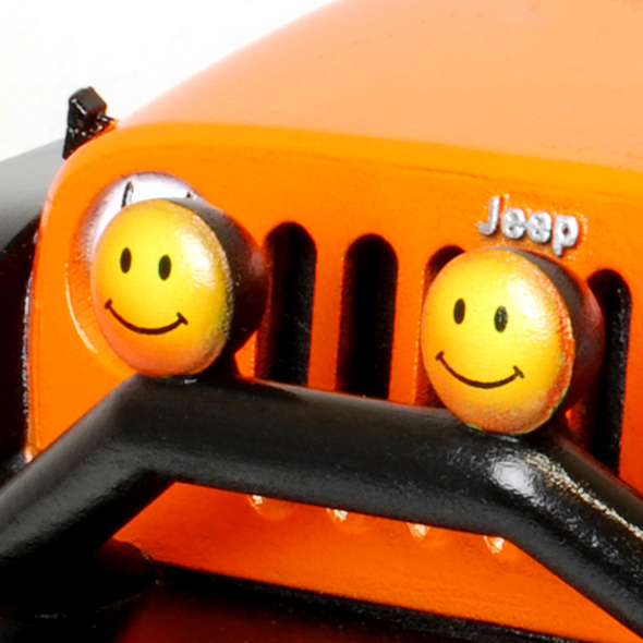 A close-up of the smiley face decals on the front of the Jeep.