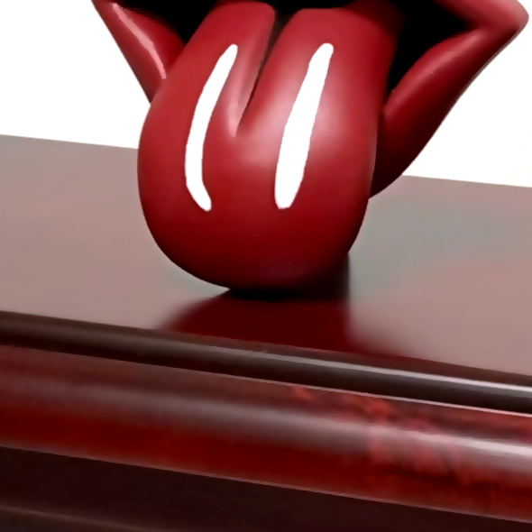 The Rolling Stones' lips 3D print on top of a wooden urn.