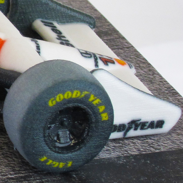 A close-up of the tires of the 3D-printed McLaren-Honda racecar.