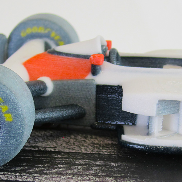A close-up of the seat and steering wheel of the 3D-printed McLaren-Honda racecar model.