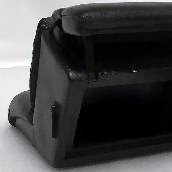 The bottom of the 3D-printed recliner urn opens up to insert ashes.