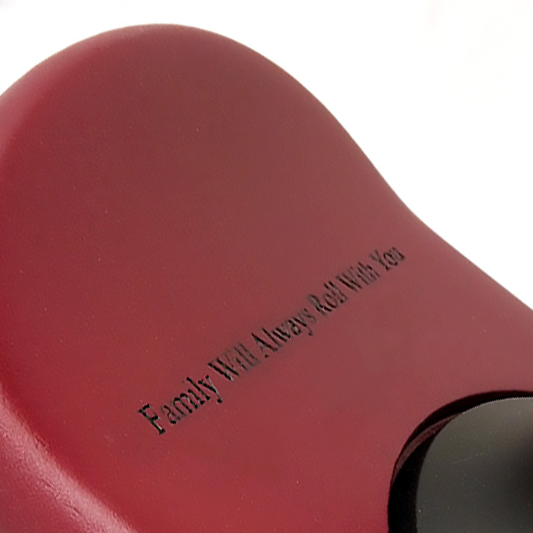 A close-up of the 3D-printed skateboard base that shows an engraving reading "Family Will Always Roll With You."