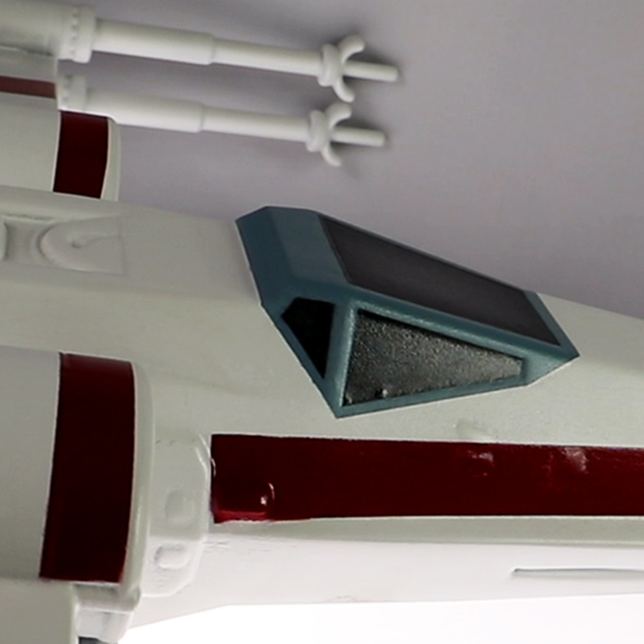 A close-up of the cockpit window on the 3D-printed X-wing.