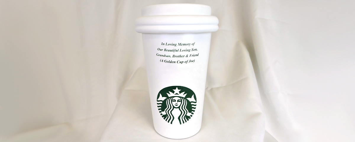 A 3D-printed custom cremation urn in the shape of a Starbucks paper cup.