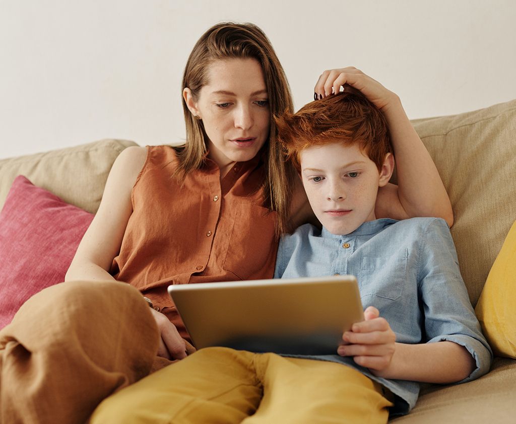 Mother and son on the couch writing a eulogy.
